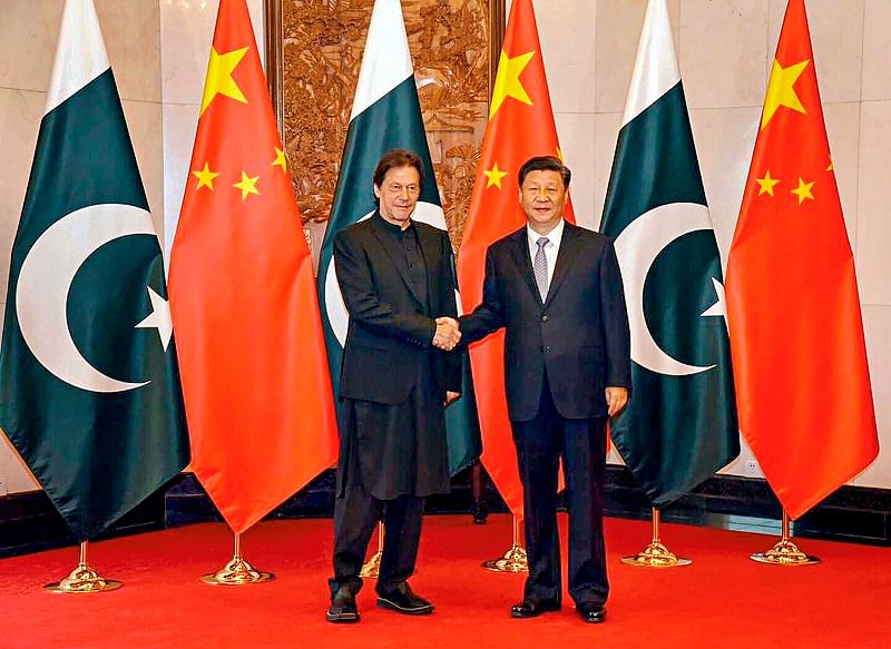 Chinese President Xi Jinping shakes hands with Pakistani Prime Minister Imran Khan, in Beijing. (AFP Photo)