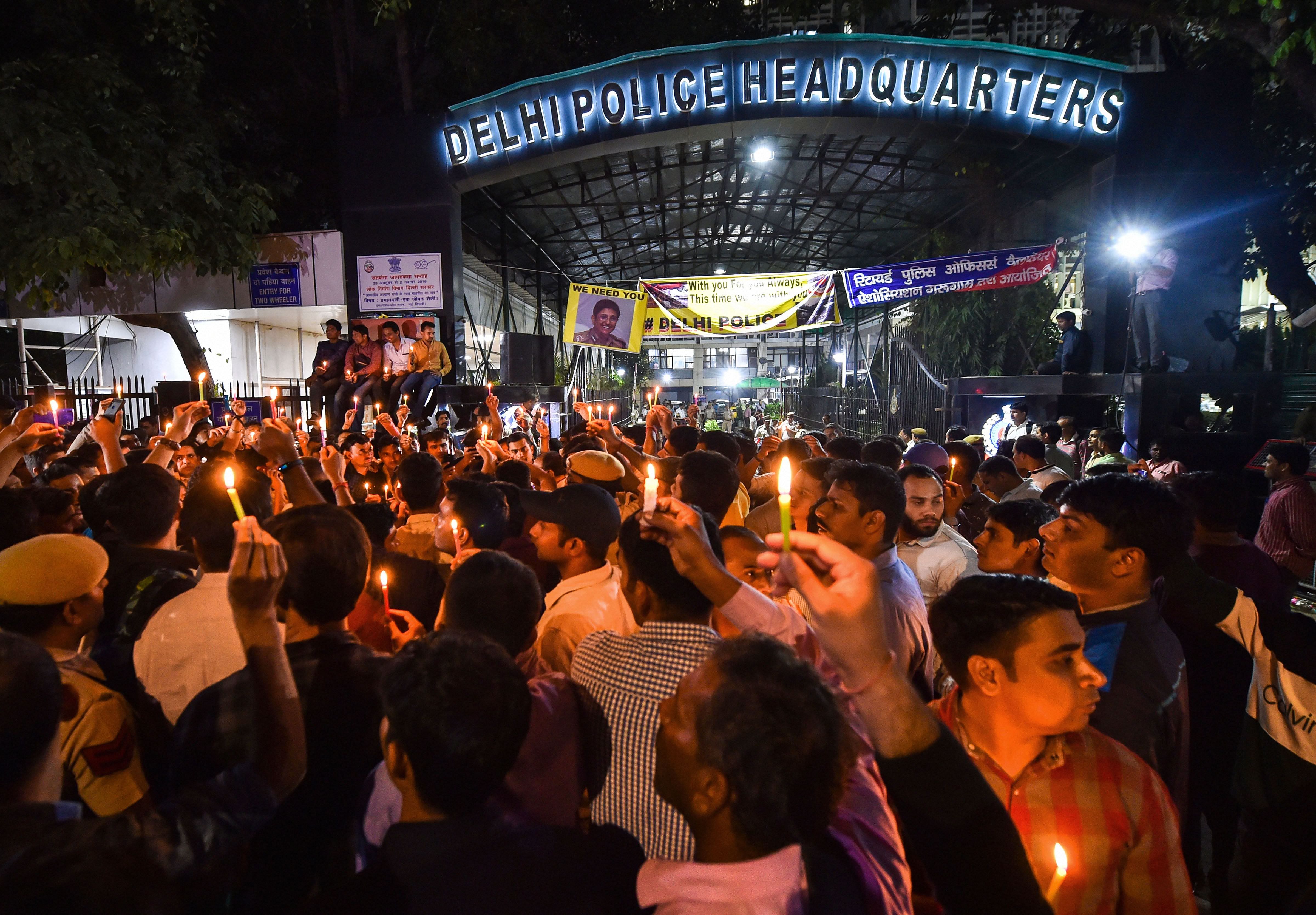 Delhi Police personnel hold a candle light protest at Delhi Police Headquarters over alleged repeated incidents of violence against them by lawyers, in New Delhi, Tuesday, Nov. 5, 2019. (PTI Photo/Manvender Vashist) 