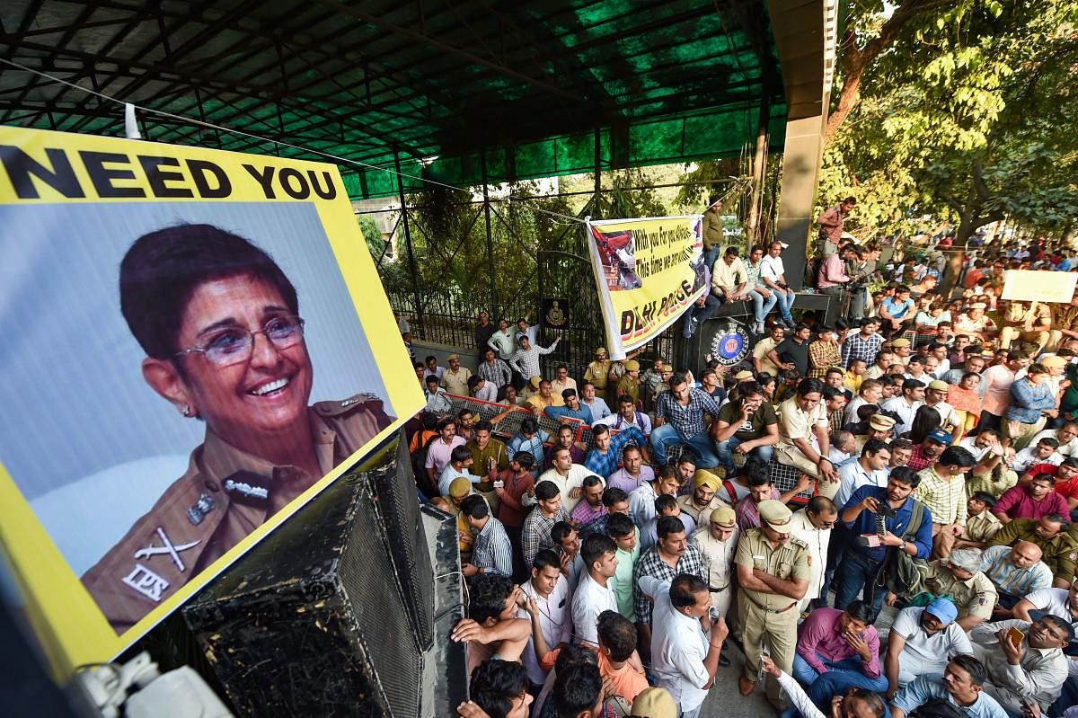 Delhi Police personnel display pictures of former IPS officer Kiran Bedi during a protest against the repeated incidents of alleged violence against them by lawyers including the Tis Hazari Court clashes, in New Delhi on Tuesday. (PTI Photo)