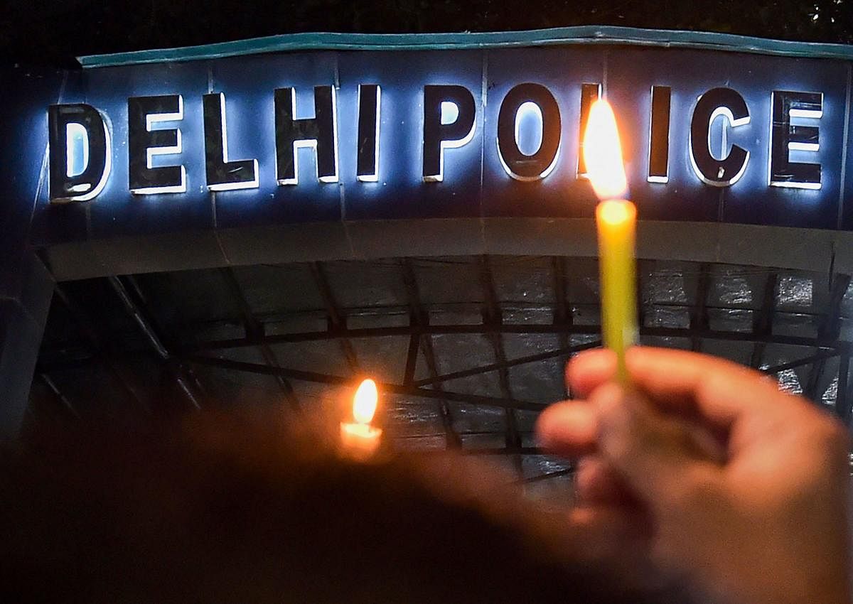 Delhi Police personnel hold a candle light protest at Delhi Police Headquarters over alleged repeated incidents of violence against them by lawyers, in New Delhi on Tuesday. (PTI File Photo)