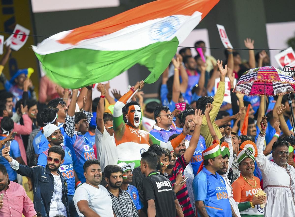  An Indian team fans cheers waving the tricolour during the second T20 cricket match between India and Bangladesh, at Saurashtra Cricket Association Stadium in Rajkot, Gujarat, Thursday, Nov. 7, 2019. (PTI Photo)