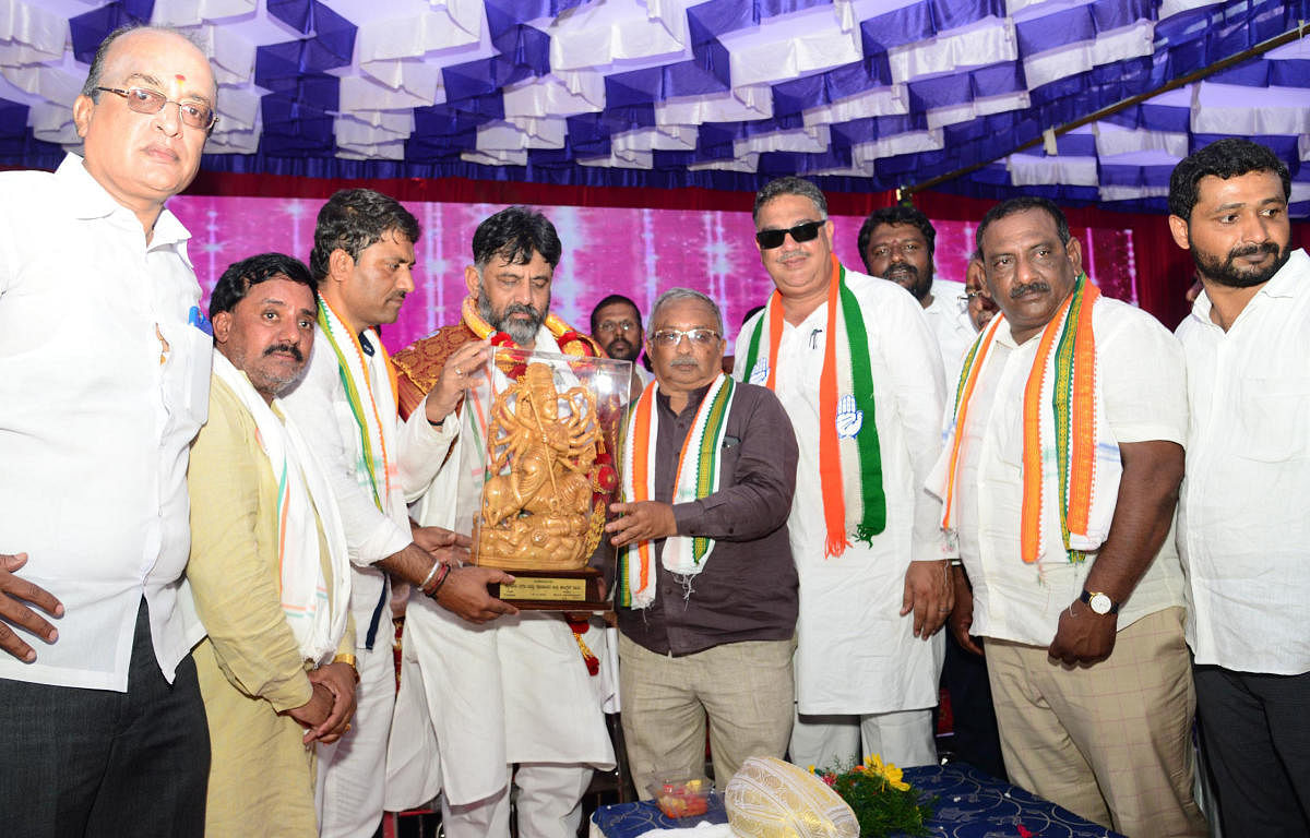 Congress leader D K Shivakumar is presented an idol of Goddess Chamundeshwari at a programme at the party office in Mysuru on Thursday. MLA Tanveer Sait and others are seen.