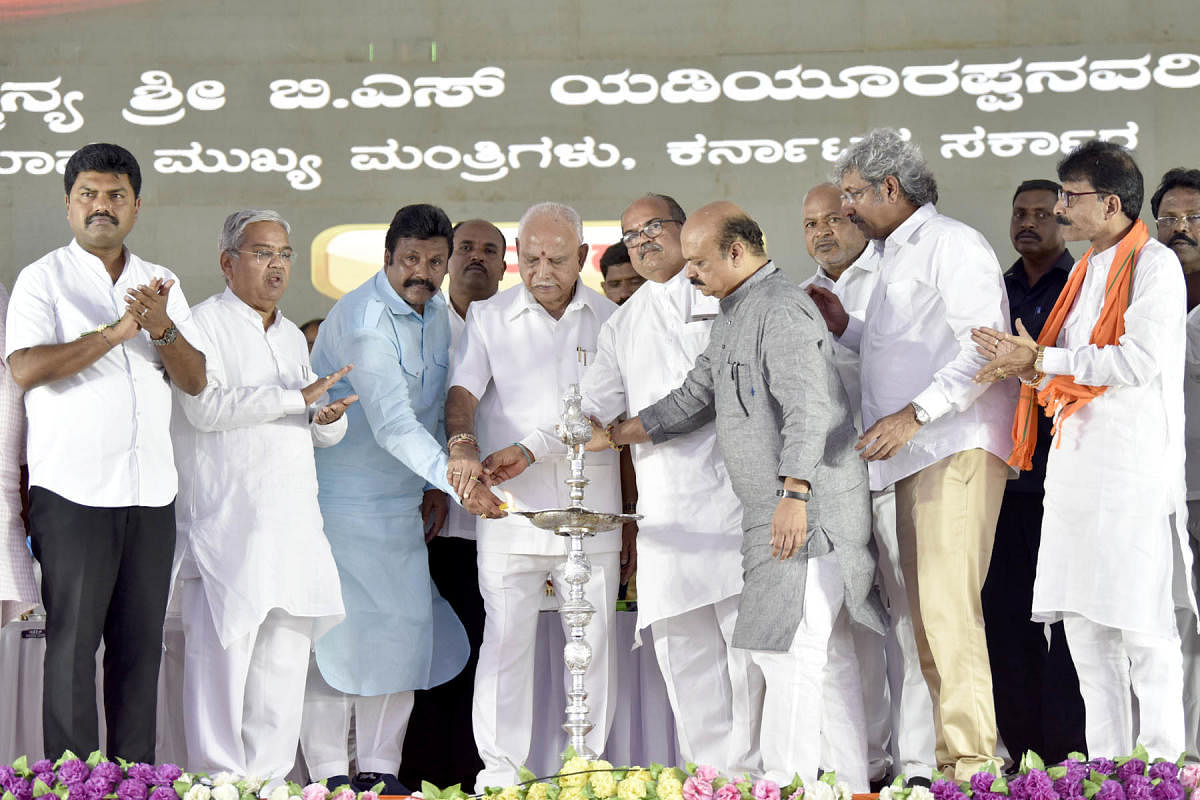 Chief Minister B S Yediyurappa, joined by disqualified Congress MLA B C Patil and BJP leader U B Banakar, inaugurates a programme in Hirekerur, Haveri district, on Thursday. Deputy Chief Minister Govind Karjol, Home Minister Basavaraj Bommai and others lo