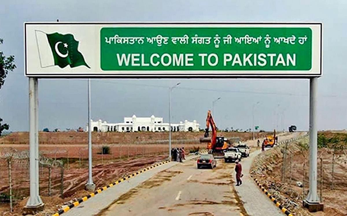 In this undated handout photo, a sign board reads, ' Welcome to Pakistan', against the backdrop of Gurdwara Kartarpur Sahib in Pakistan. PTI