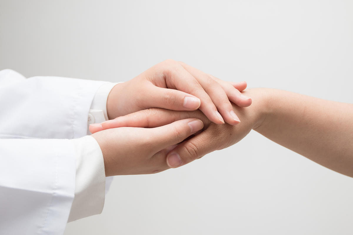 Doctor holding a woman's hand