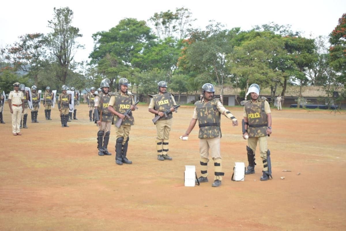 Police personnel engage in a mock exercise on security at police grounds in Madikeri. dh photo 
