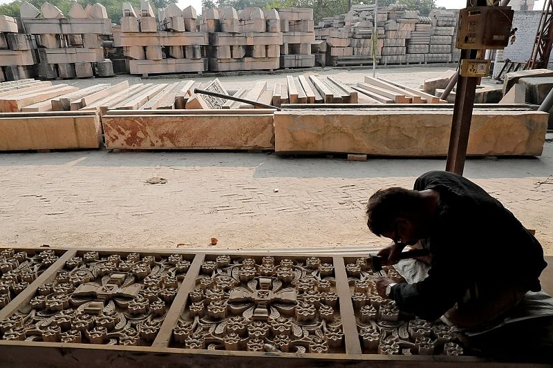 A worker engraves a stone that Hindu groups say will be used to build a Ram temple at a disputed religious site in Ayodhya in the northern state of Uttar Pradesh. (Reuters Photo)