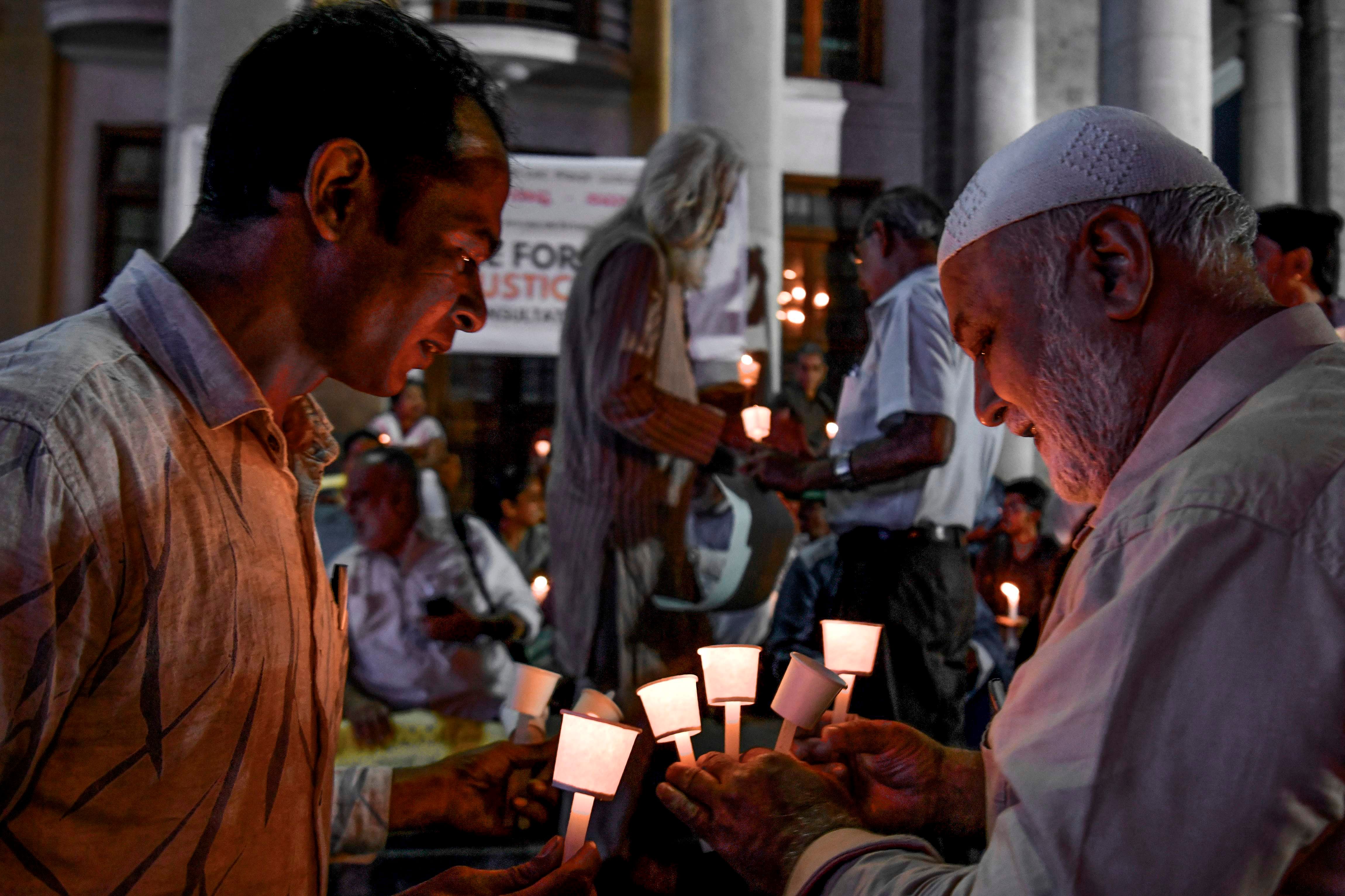 Activists belonging to 'People for Peace and Justice' stage a candle light vigil urging people belonging to all religious communities to maintain peace and harmony regardless of the outcome of the Supreme Court verdict on Ayodhya’s Ram Janmabhoomi case. (AFP Photo)