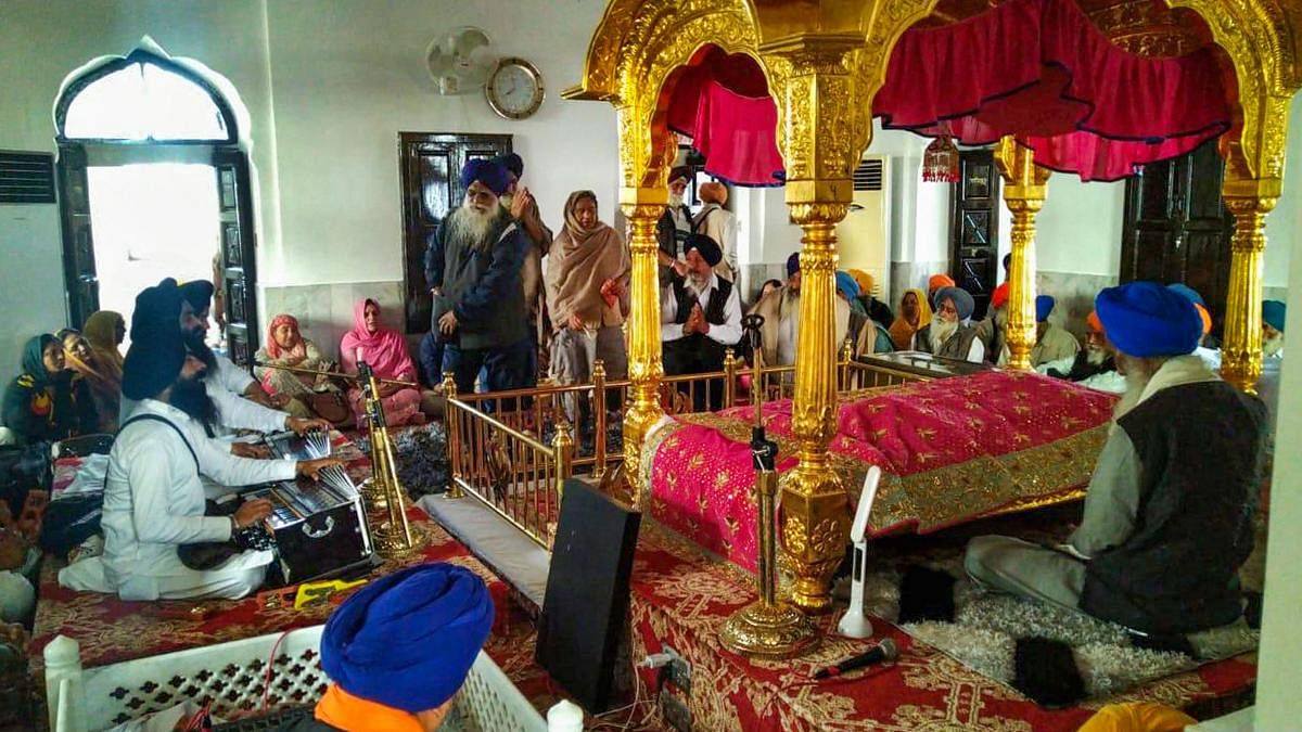 Devotees offers prayer at Gurdwara Kartarpur Sahib in Pakistan. (PTI Photo)
