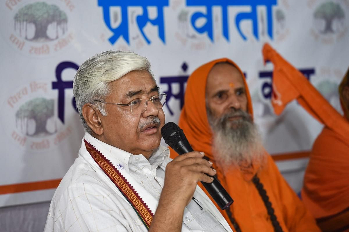 VHP working president Alok Kumar addresses a press conference as spiritual leader Swami Parmanand looks on, in New Delhi on Friday. PTI