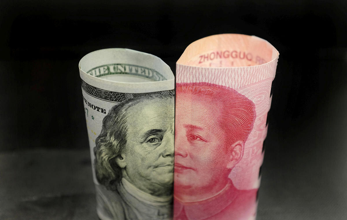 The currency of U.S. 100 dollar banknote and a Chinese 100 Yuan banknote.(REUTERS Photo)