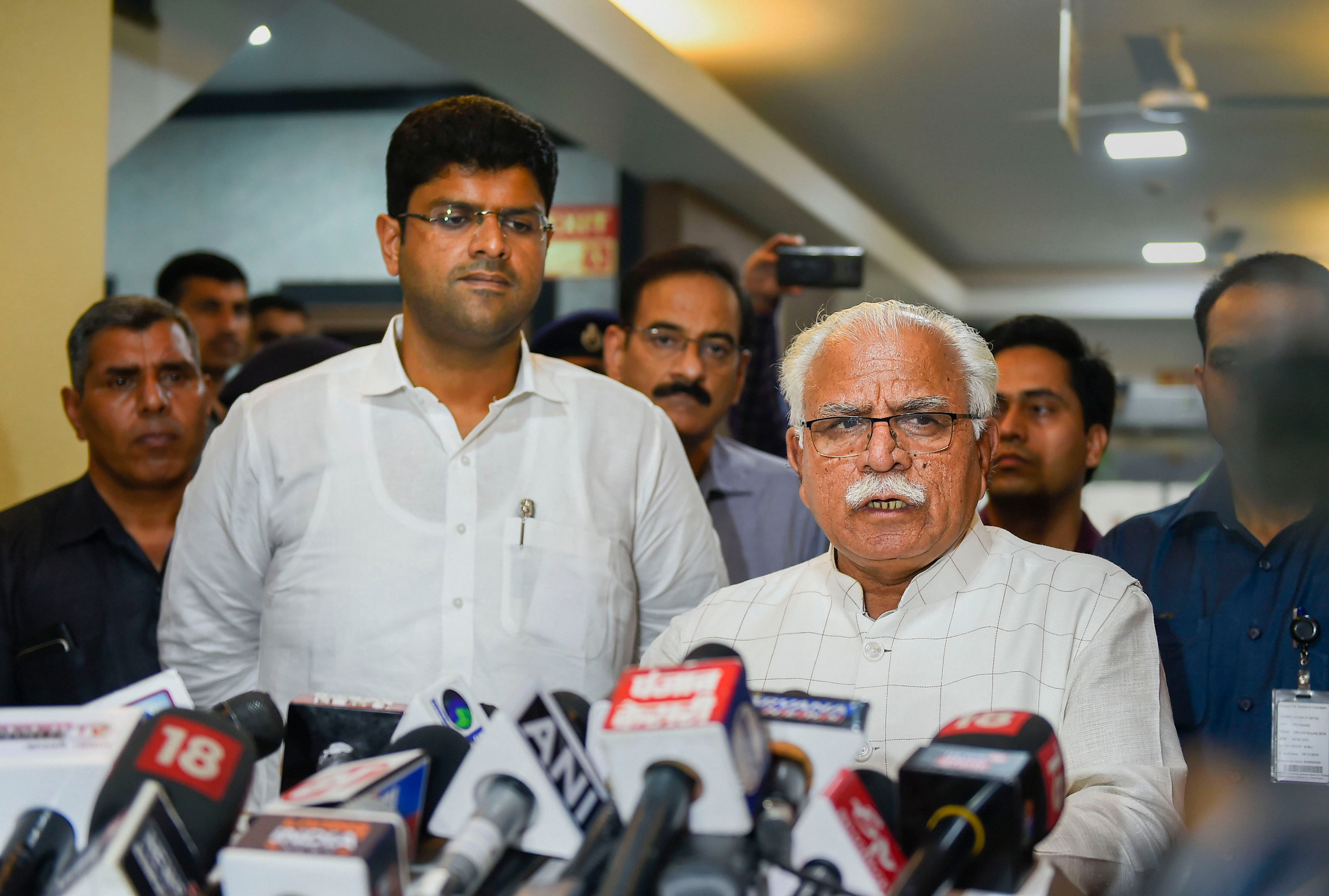 Haryana Chief Minister Manohar Lal Khattar speaks during a press conference after a meeting as Deputy Chief Minister Dushyant Chautala looks on, at Haryana Bhawan in New Delhi. (PTI Photo)