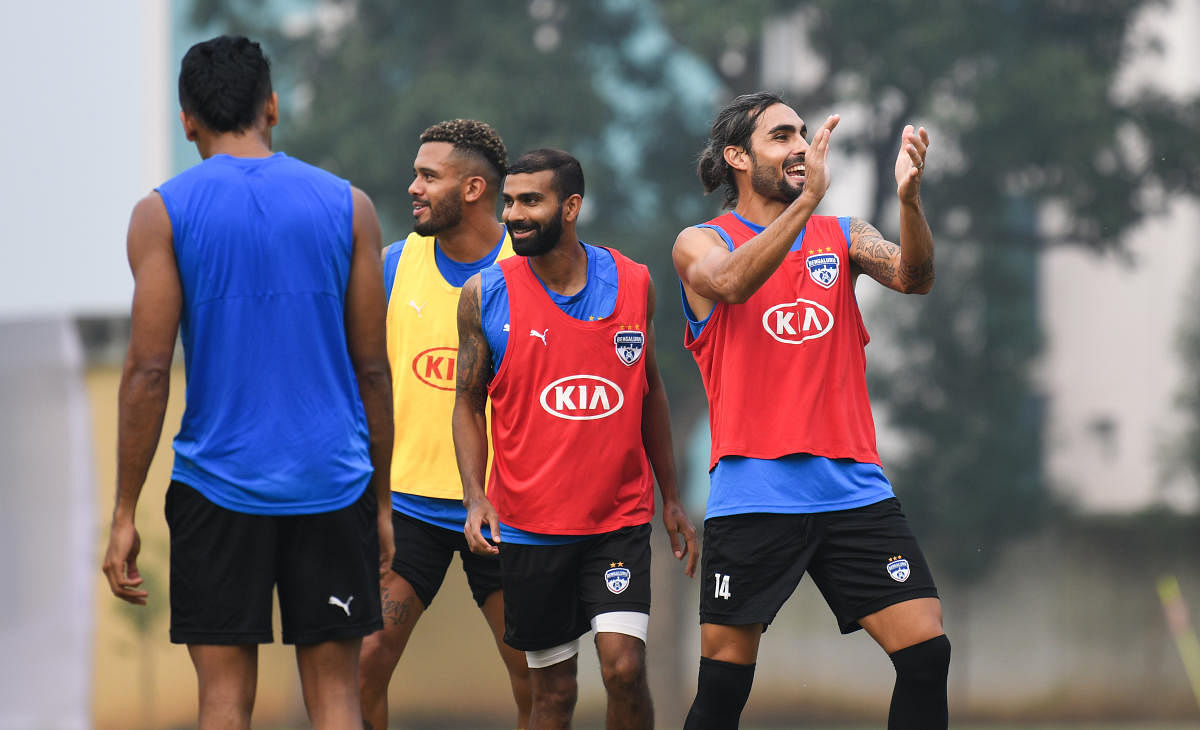 Bengaluru FC players share a light moment during a training session on the eve of their match against Chennaiyin FC in Bengaluru on Saturday. BFC MEDIA