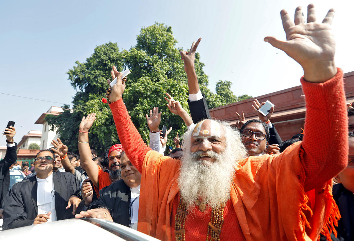 Mahant Dharam Das, chief Priest of Nirmohi Akhara, celebrates after Supreme Court's verdict on a disputed religious site, outside the court in New Delhi, India, November 9, 2019. REUTERS/Adnan Abidi