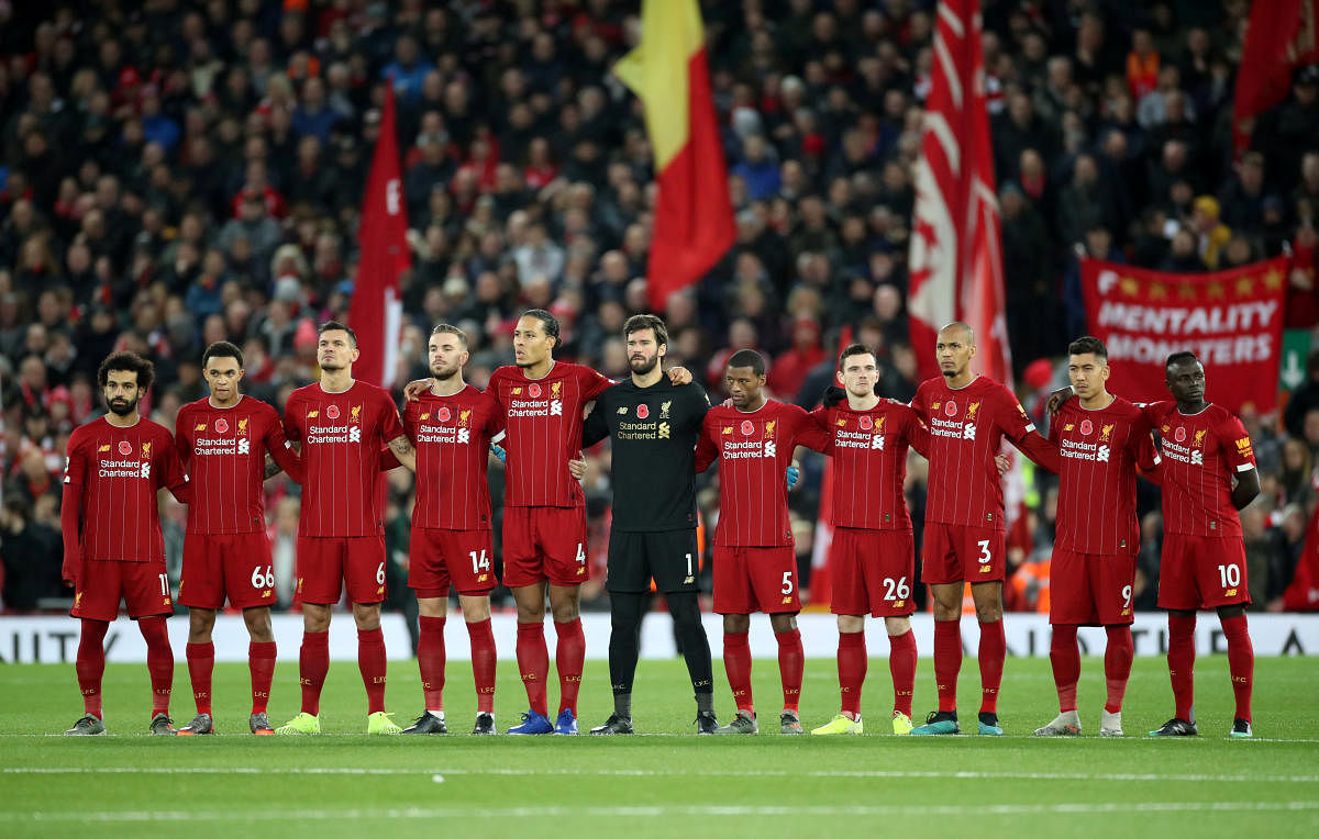 Liverpool players during a minutes silence as part of remembrance commemorations before the match. (Reuters file photo)