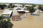 An inundated village in food affected Mehboobnagar district of Andhra Pradesh on Monday. PTI