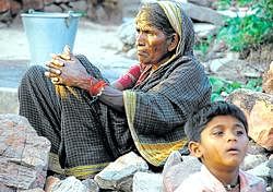 An old woman seen with her grandson at the flood-hit Hiremagi village, in Bagalkot. File photo/KPN