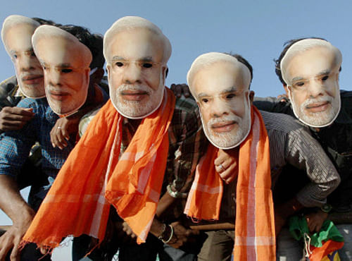 Supporters wearing the mask of BJP's Prime Ministerial candidate Narendra Modi during a rally at Vandalur near Chennai on Saturday. PTI Photo