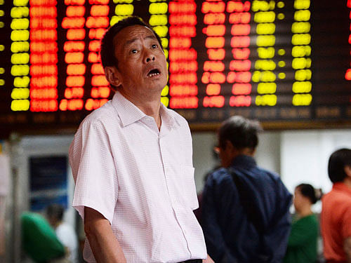 A man reacts as he looks at stock market prices at a brokerage house in Shanghai, China, Monday, June 29, 2015. AP Photo