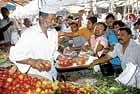 A vegetable vendor busy attending to customers when curfew was relaxed for 90 minutes in Shimoga on Wednesday. dh photo