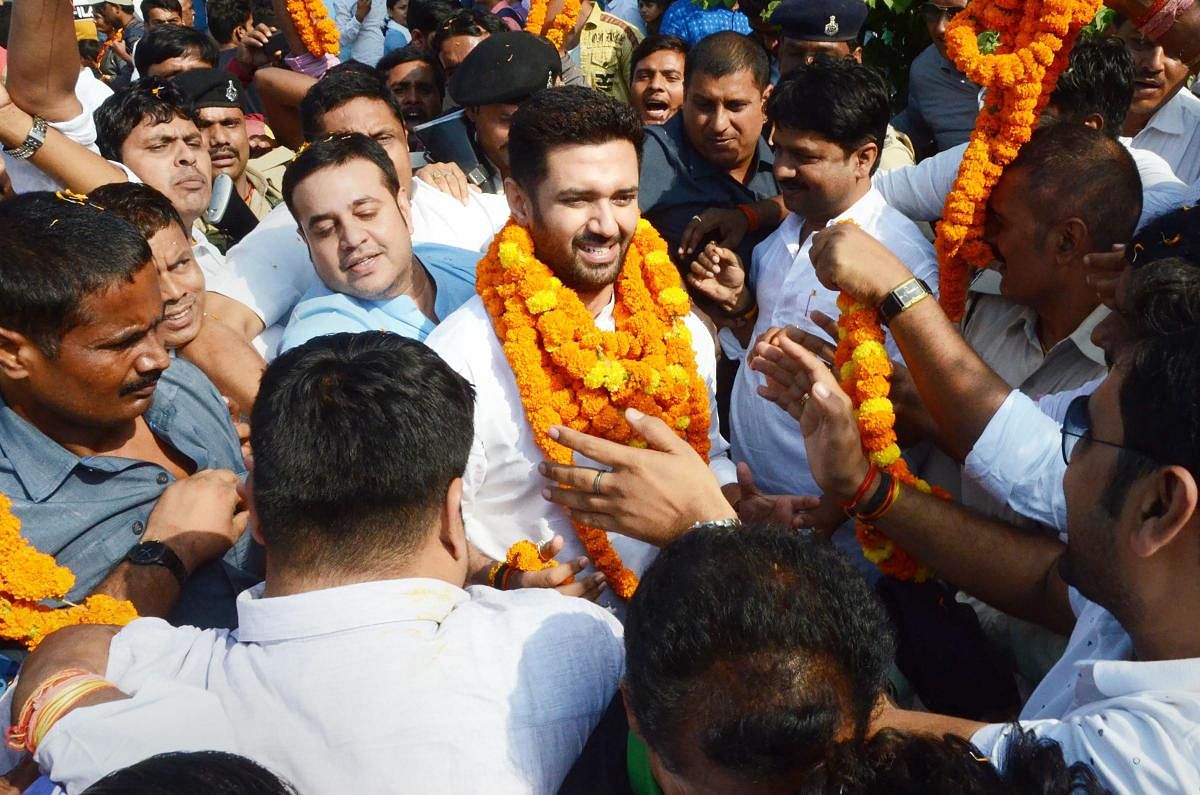 Lok Janshakti Party President Chirag Paswan is garlanded by his party supporters on his arrival, in Patna. Representative Image. (PTI Photo)