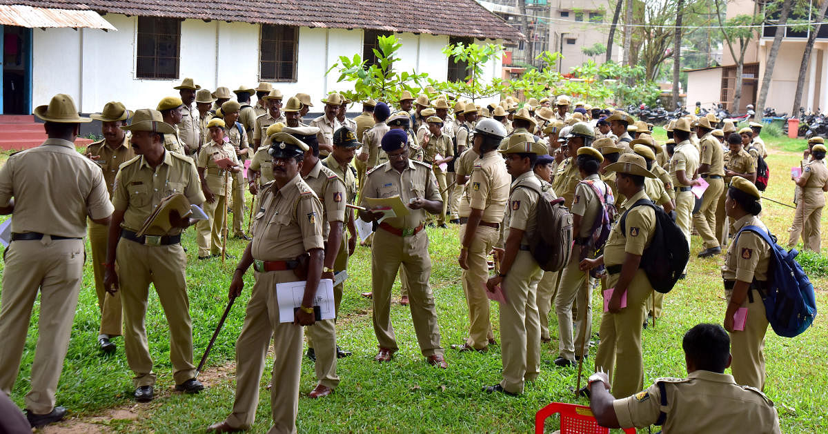 Police personnel in Mangaluru get ready to leave for the polling booths for the MCC elections.