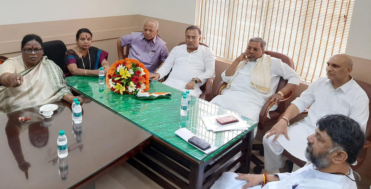 (From left) Former ministers Motamma, Umashri, S R Patil, KPCC president Dinesh Gundurao, leader of the Opposition Siddaramaiah and former minister D K Shivakumar at a party meeting in Bengaluru on Monday.
