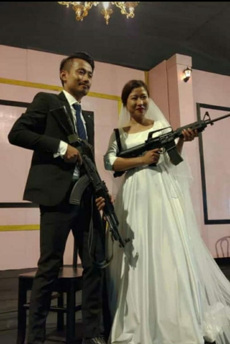 The Naga bride-groom with assault rifles at the marriage ceremony. (DH photo)