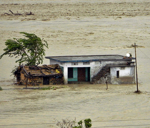 A house submerged in water from the Tehsil river in Dehradun on Monday. AP