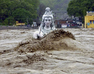 A submerged idol of Lord Shiva stands in the flooded River Ganges in Rishikesh, in Uttarakhand on Tuesday, June 18, 2013. Monsoon torrential rains have cause havoc in northern India leading to flash floods, cloudbursts and landslides as the death toll continues to climb and more than 1,000 pilgrims bound for Himalayan shrines remain stranded. (AP Photo)