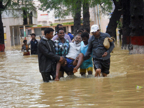 A patient is shifted from a flooded hospital in Baripada on Thursday. PTI Photo