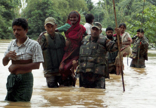 Army jawans rescue flood-affected people at Chaigaon in Kamrup on Thursday. PTI