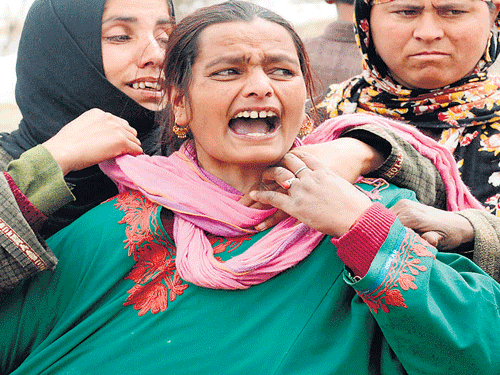 A villager cries for a missing relative in Laden village, some 40 km west of Srinagar, on Monday. AFP Photo