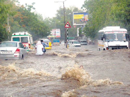 Vehicles trapped in torrential rain in Jodhpur on Thursday.