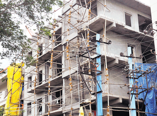 A building under construction on 3rd main in AGS Layout is too close to electricity poles.