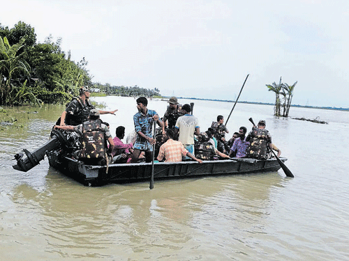 flood fury: Army jawans rescue marooned people in lower Assam on Friday.