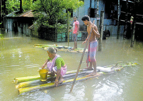 People use a banana raft to commute in a flooded area after heavy rain in Alipurduar,&#8200;West Bengal on Sunday. PTI Photo