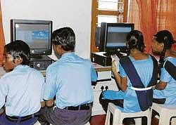 Schoolchildren from flood-affected families use computers at a centre opened by SAP and Hope foundation on the outskirts of Jageeravenkatapura in Raichur  taluk on Friday. KPN