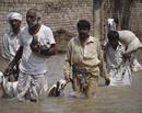 Pakistani flood affected villagers move to safer areas in Muzaffargarh, Pakistan on Friday, Aug. 13, 2010. Fever, stomach problems and skin diseases are spreading among Pakistani flood victims, officials said Friday, adding another dimension of danger to a crisis that could get even worse, with the U.N. warning that dams in the south may burst.AP