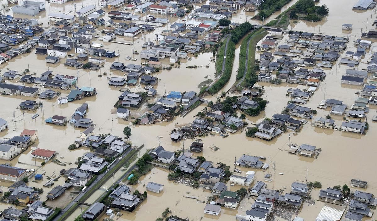 Kurashiki : Houses are submerged by muddy water following heavy rain in Kurashiki city, Okayama prefecture, southwestern Japan, Sunday, July 8, 2018. Heavy rainfall hammered southern Japan for the third day, prompting new disaster warnings on Kyushu and Shikoku islands on Sunday. AP/PTI