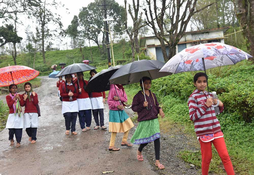 Children on their way to classes as a few schools reopened in Madikeri on Thursday. DH Photo