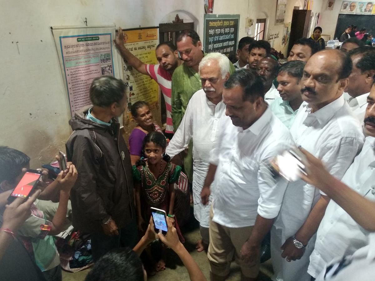 Revenue Minister R V Deshpande, Minister for Urban Development and Housing U T Khader interact with the victims at one of the relief centres in Sampaje on Sunday. 
