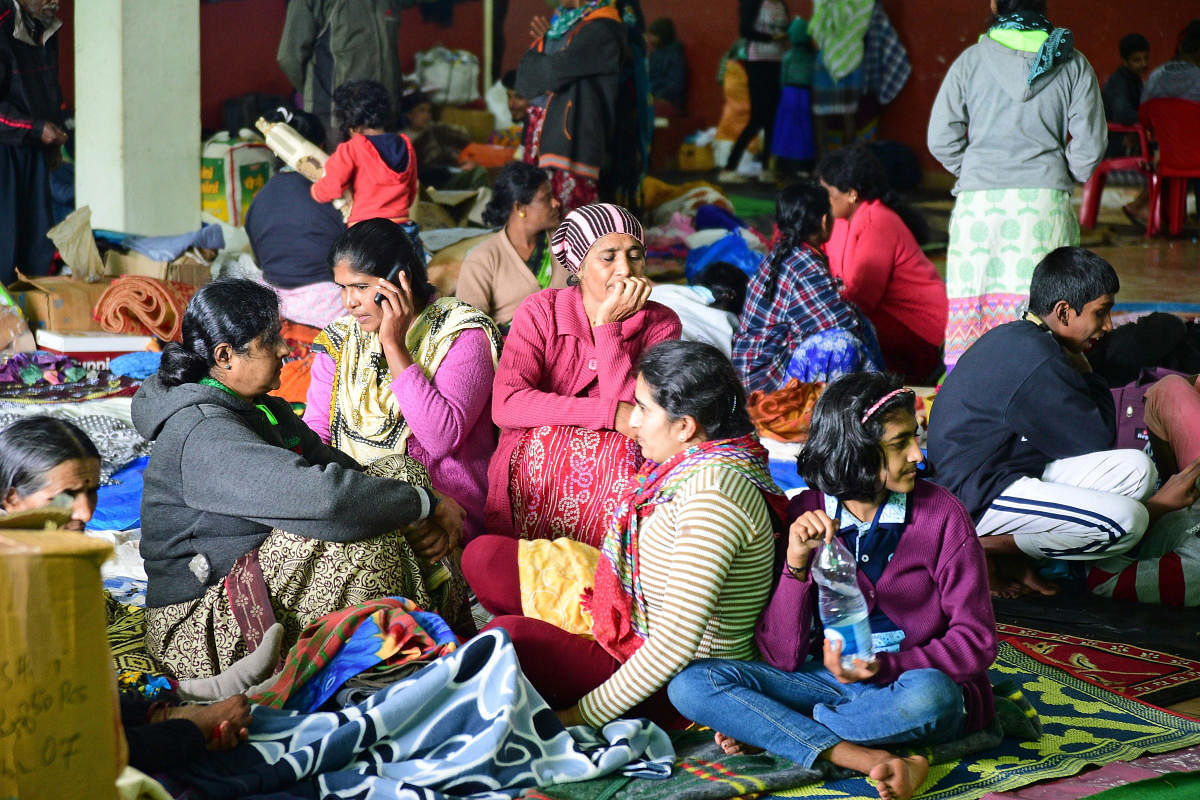 Flood-hit people are at their wit's end at a relief camp in Madikeri on Monday. dh photo