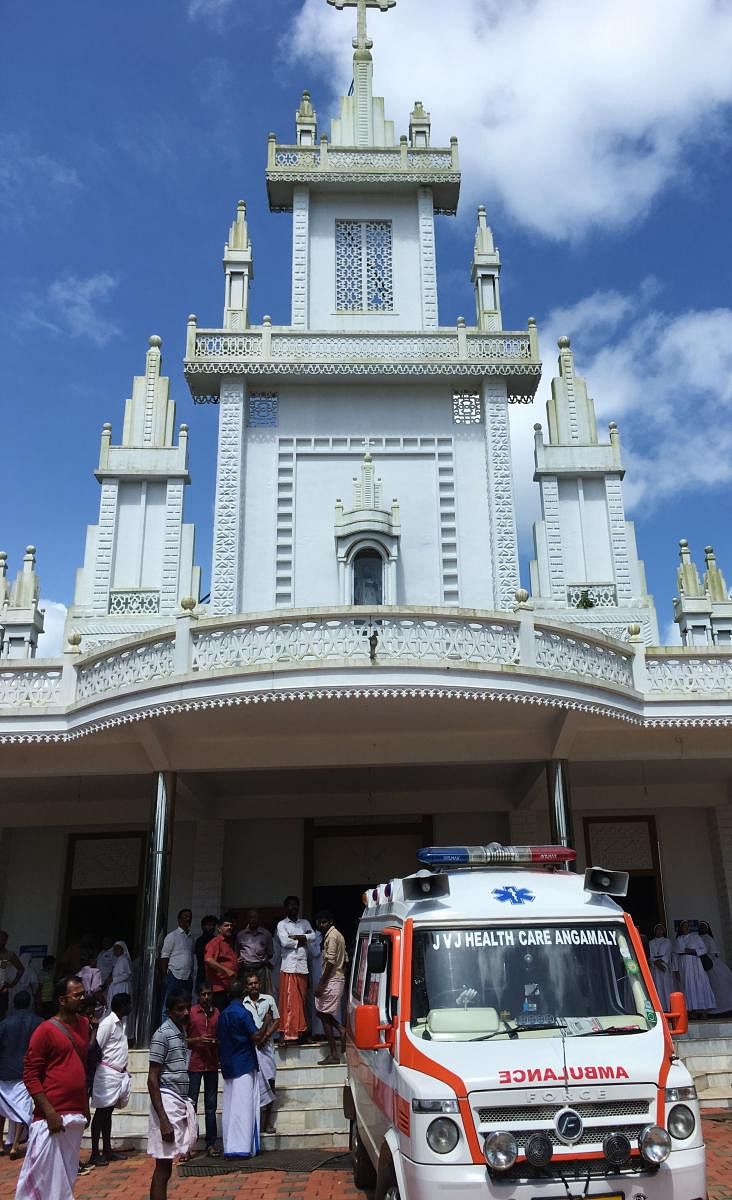 An ambulance brings the dead to the church in Kuthiathode on Tuesday. DH Photo/ R Krishnakumar