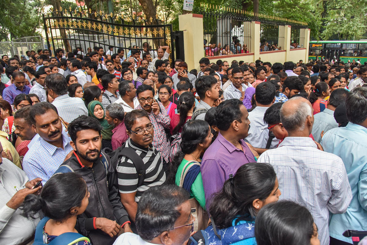 Anxious students and parents outside the KEA office on Friday. DH PHOTO/S K DINESH