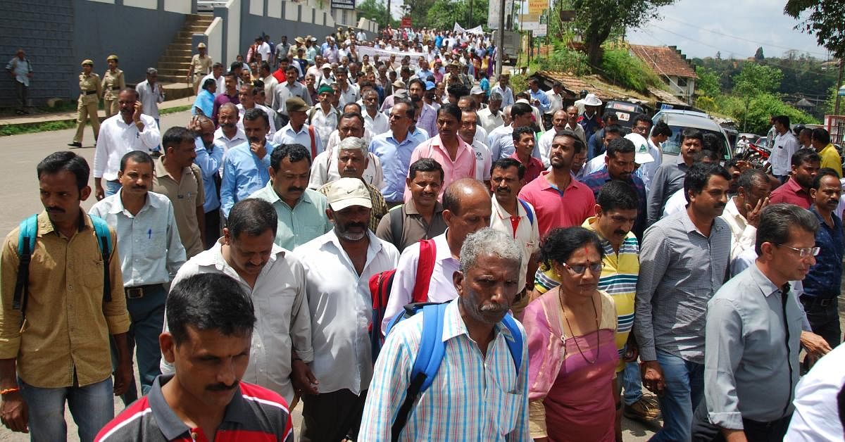 Growers stage a protest in Madikeri on Friday.