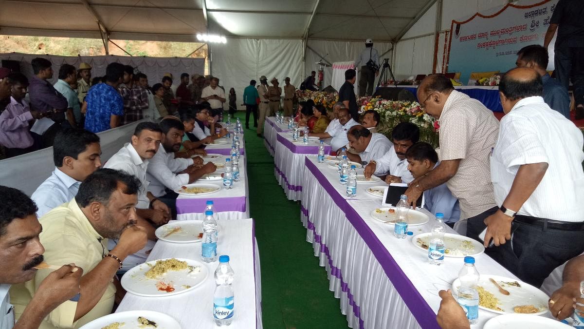 Chief Minister H D Kumaraswamy having lunch with flood victims in Madikeri.