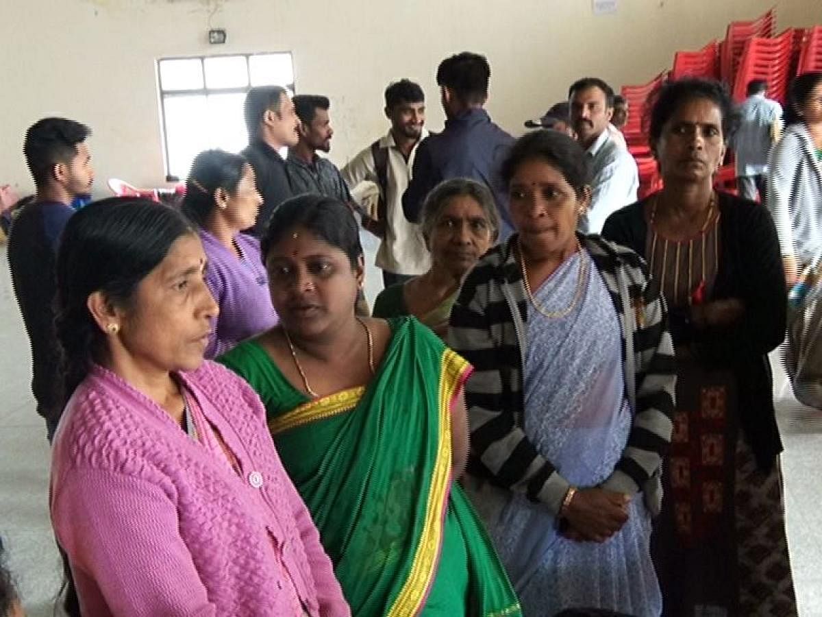 Victims who were taking shelter at the Maitri relief centre in Madikeri stage a flash protest on Monday, opposing the move of the district administration to vacate them from the hall.