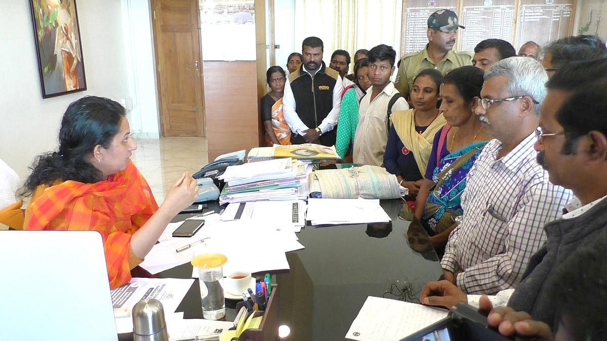 Flood victims who have been staying at Maitri Hall in Madikeri submit a memorandum to Deputy Commissioner P I Sreevidya on Tuesday.