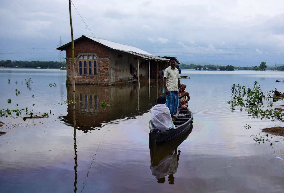 Villagers are transported on a boat towards a safer place at a flooded village in Nagaon district in Assam on Monday. About 43 lakh people have been affected by floods that have claimed 15 lives so far.Page 12